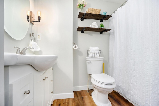 bathroom featuring vanity, hardwood / wood-style flooring, and toilet