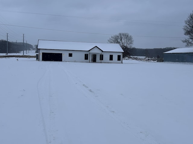 view of front of house featuring a garage and an outdoor structure