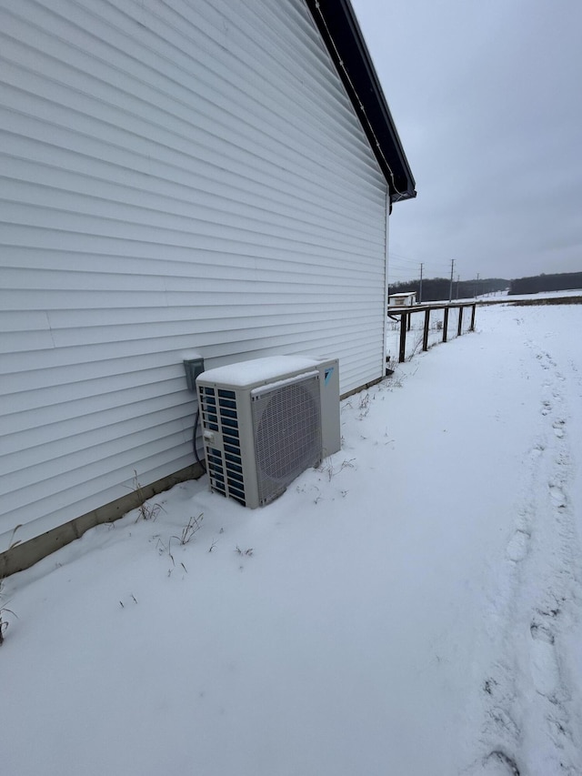 view of snow covered exterior featuring ac unit