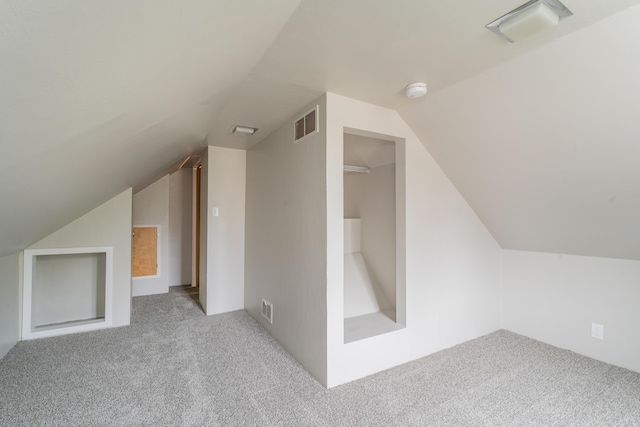 bonus room with light carpet and lofted ceiling