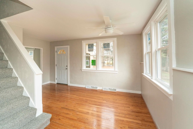 entryway featuring a wealth of natural light, ceiling fan, and light hardwood / wood-style flooring