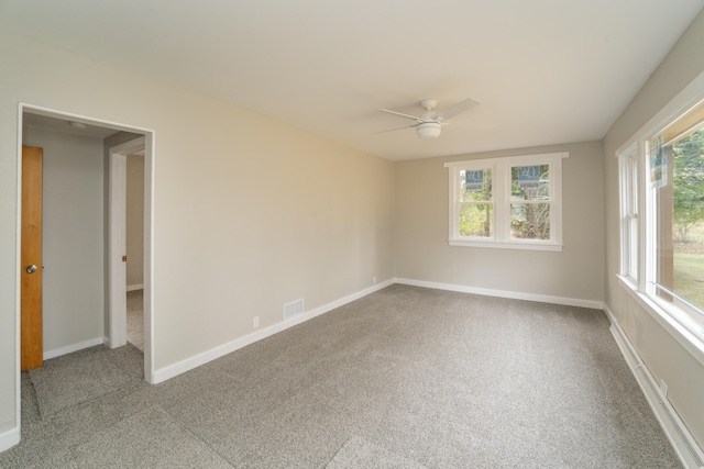 carpeted spare room with ceiling fan