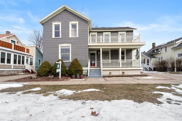 view of front of home featuring a balcony and covered porch