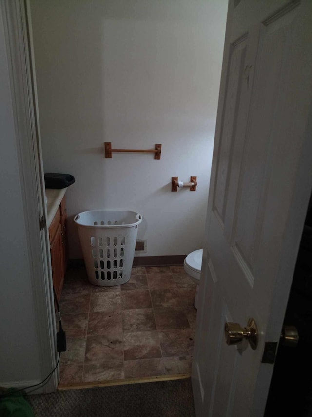 bathroom with toilet and vanity