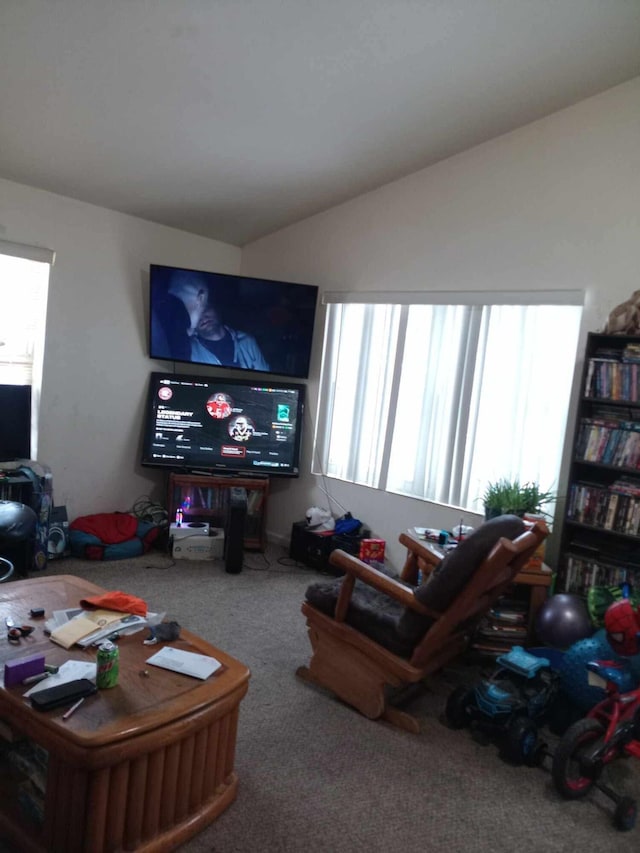 carpeted living room featuring plenty of natural light and lofted ceiling