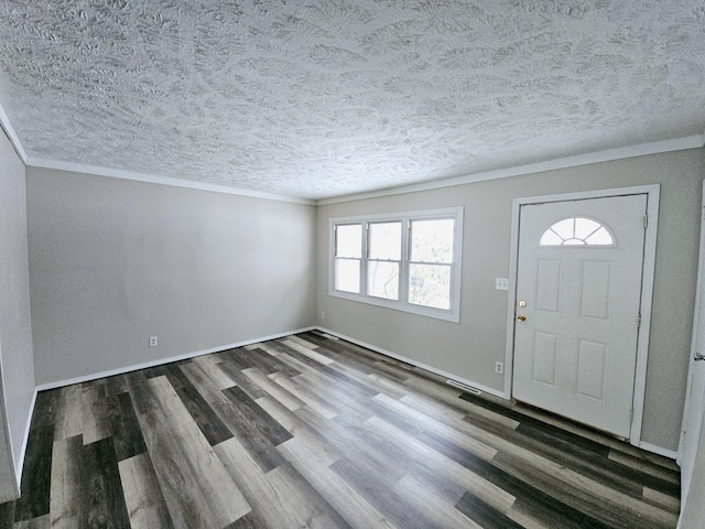 foyer with ornamental molding, dark hardwood / wood-style flooring, and a textured ceiling