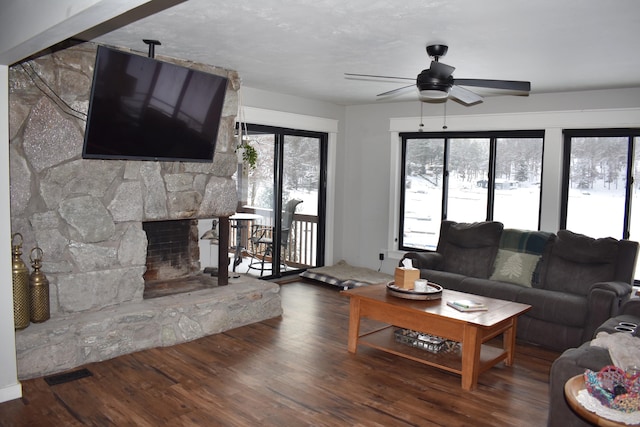 living room featuring a fireplace, ceiling fan, and dark hardwood / wood-style floors