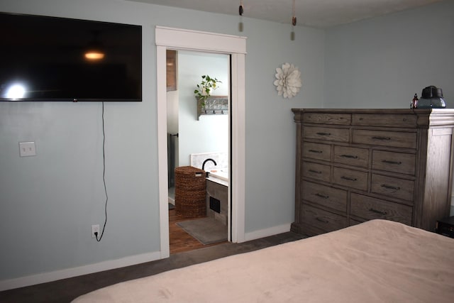 carpeted bedroom featuring ensuite bath