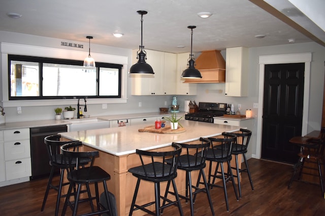 kitchen with dishwasher, range, a center island, a breakfast bar, and white cabinets