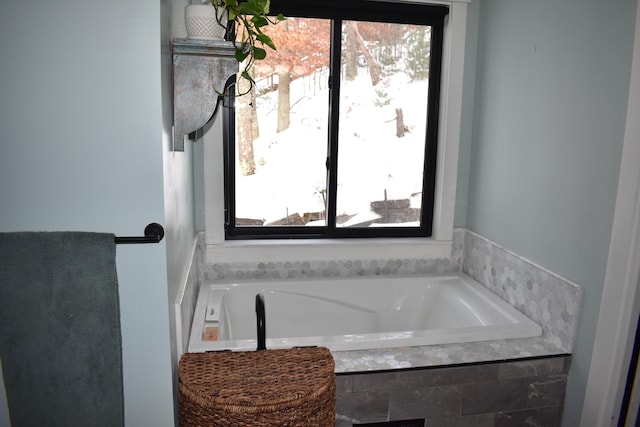 bathroom featuring a relaxing tiled tub