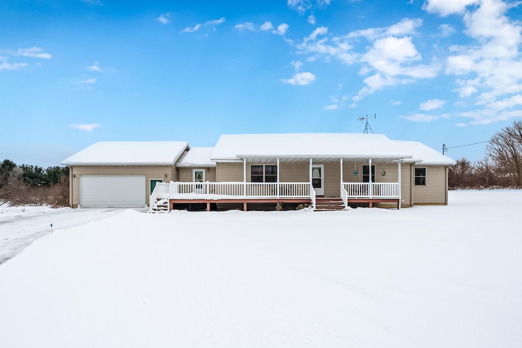 view of front of property with a porch and a garage