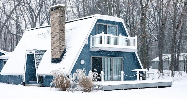 snow covered house with a balcony