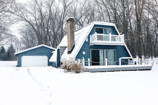 view of front of home featuring a garage and a balcony