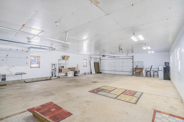 garage with a garage door opener and fridge