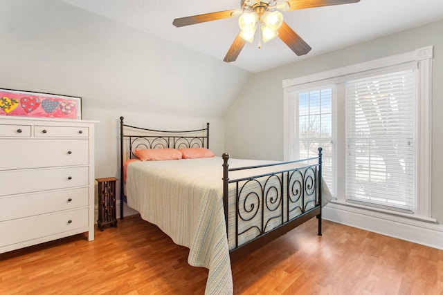 bedroom with hardwood / wood-style flooring, ceiling fan, and lofted ceiling