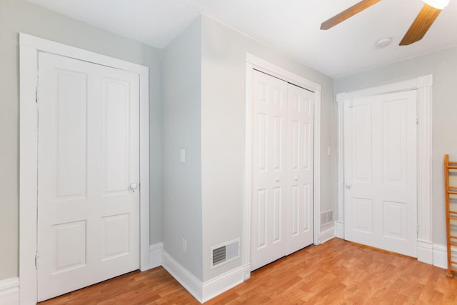 unfurnished bedroom featuring light wood-type flooring and ceiling fan