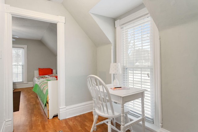 interior space with hardwood / wood-style flooring, plenty of natural light, and lofted ceiling