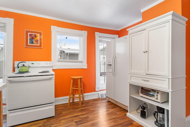 kitchen with white cabinets, white appliances, dark hardwood / wood-style floors, and crown molding