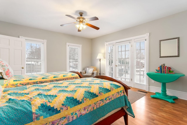 bedroom featuring wood-type flooring, access to outside, and ceiling fan