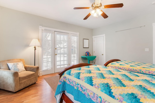 bedroom featuring access to exterior, ceiling fan, and light hardwood / wood-style flooring