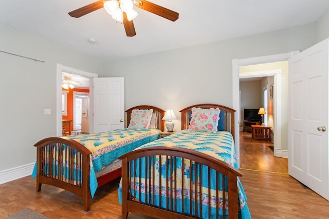 bedroom with hardwood / wood-style floors and ceiling fan