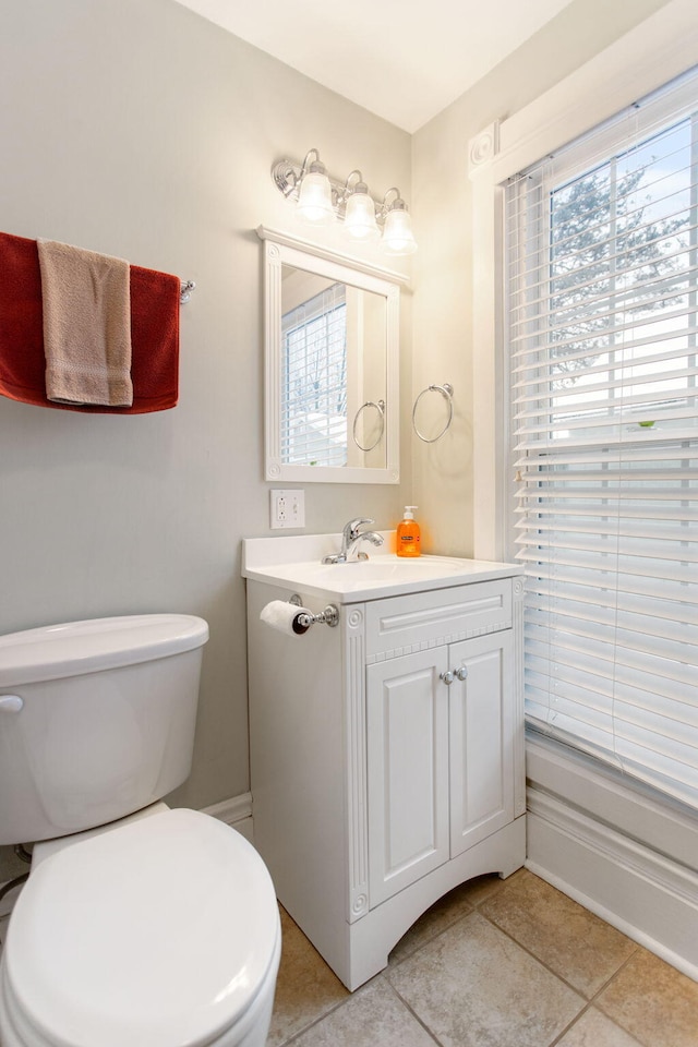 bathroom featuring tile patterned flooring, vanity, and toilet