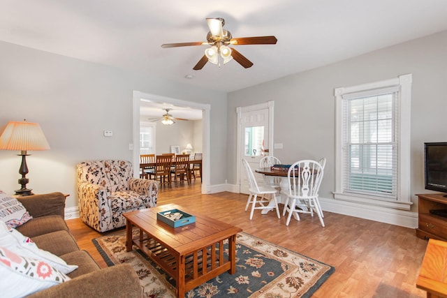 living room featuring ceiling fan and hardwood / wood-style floors