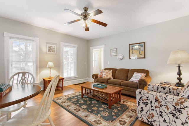 living room with light hardwood / wood-style floors and ceiling fan