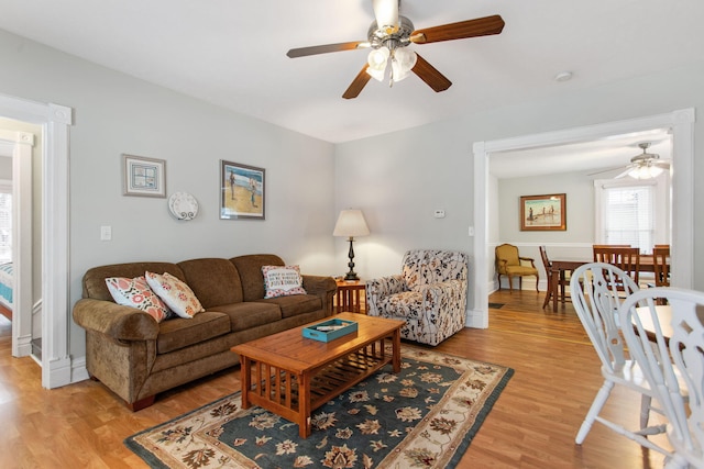 living room with ceiling fan and light wood-type flooring