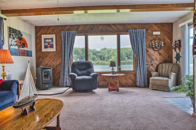 living room with light carpet, a wealth of natural light, beamed ceiling, and wood walls