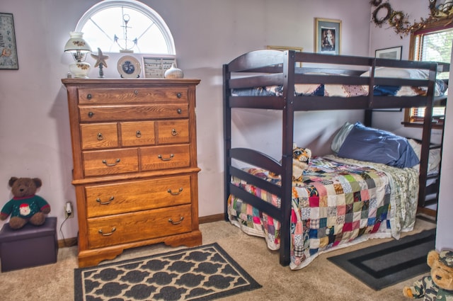 carpeted bedroom featuring multiple windows