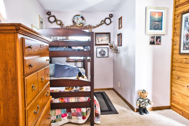 bedroom featuring carpet and a textured ceiling