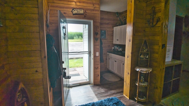 foyer featuring wood walls and hardwood / wood-style flooring