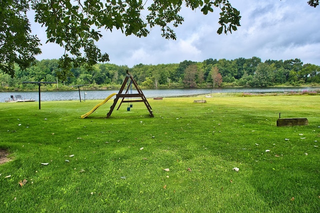 surrounding community featuring a water view and a lawn