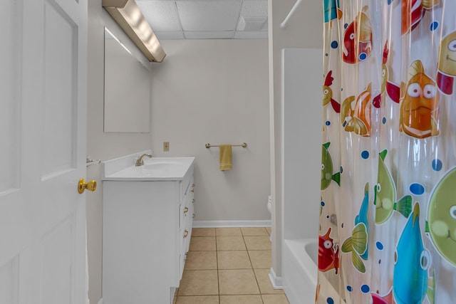 bathroom with shower / bathtub combination with curtain, a paneled ceiling, vanity, and tile patterned flooring