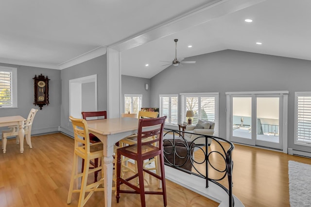 dining room featuring a baseboard radiator, lofted ceiling, ceiling fan, light hardwood / wood-style flooring, and crown molding