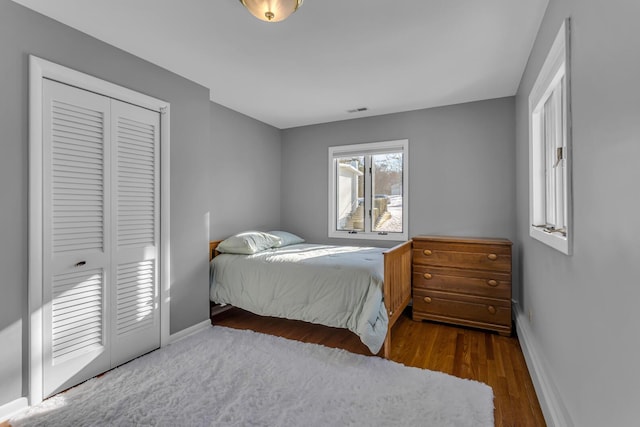 bedroom featuring a closet and dark hardwood / wood-style flooring