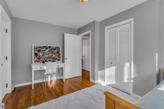 bedroom featuring hardwood / wood-style floors and a closet