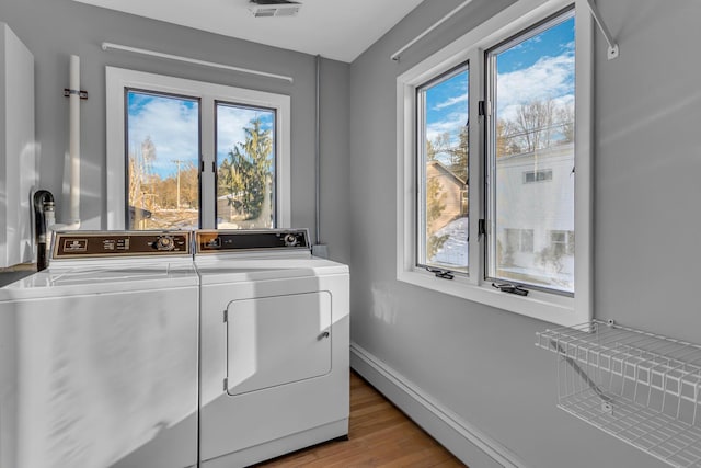 laundry area featuring light hardwood / wood-style floors and separate washer and dryer