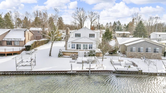 rear view of house featuring a water view