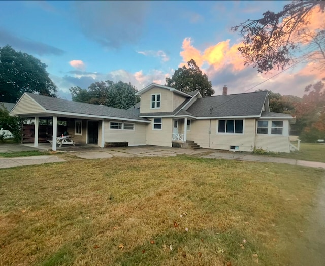 view of front facade featuring a lawn and a patio