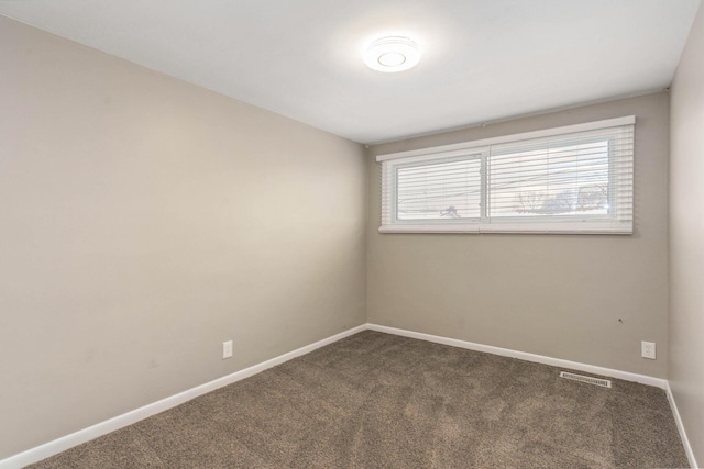 carpeted spare room with baseboards and visible vents