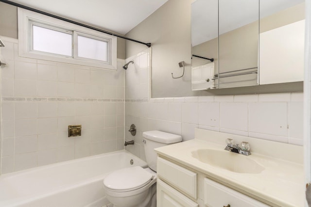 bathroom with vanity, shower / tub combination, wainscoting, tile walls, and toilet