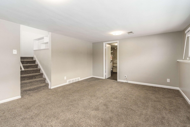 interior space featuring carpet, baseboards, and visible vents