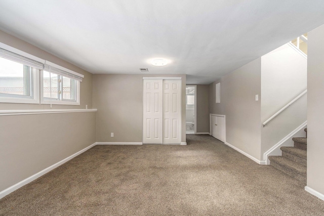 interior space featuring baseboards, a closet, carpet floors, and visible vents