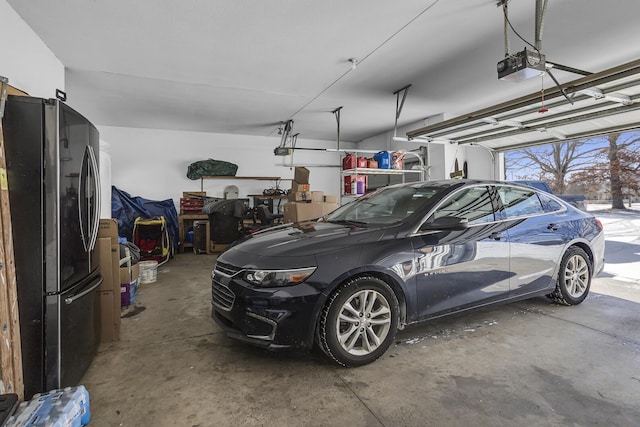 garage with a garage door opener and fridge