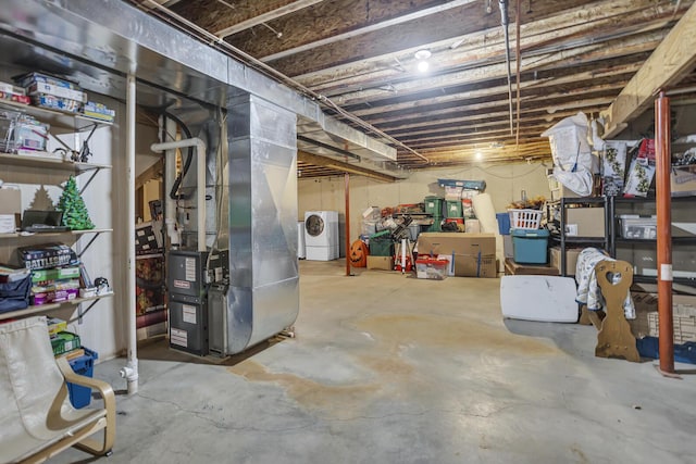 basement with washer / dryer and heating unit