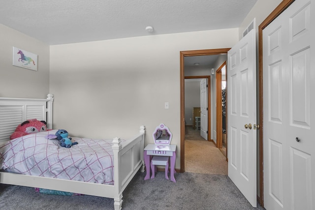 carpeted bedroom featuring a textured ceiling