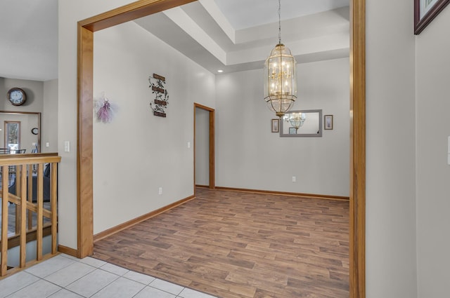 unfurnished room with light hardwood / wood-style flooring and a notable chandelier