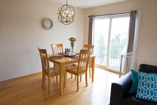 dining space with a chandelier and light hardwood / wood-style flooring